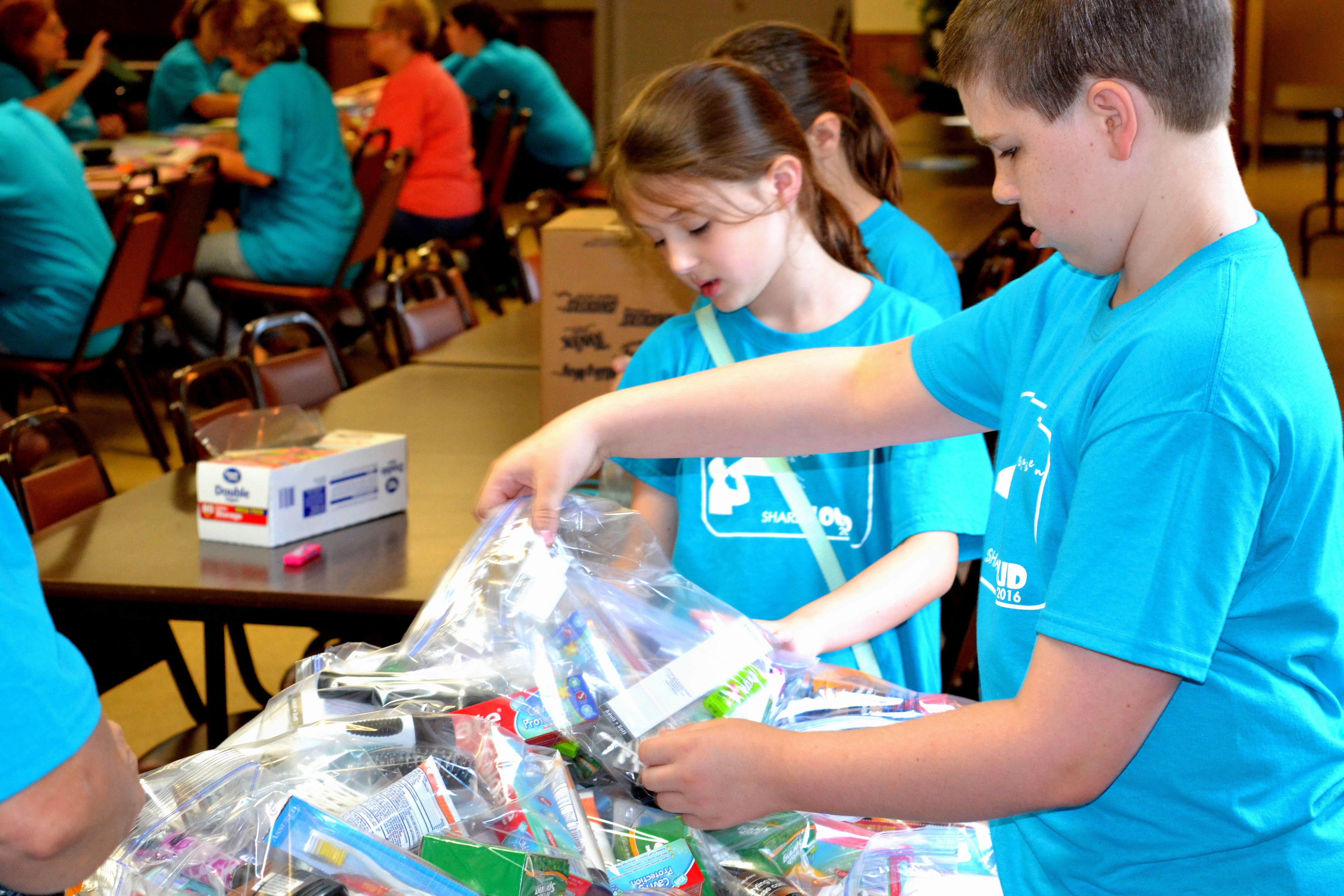 2nd-5th grade Sunday School class assembling bags for Tar Heel Middle School students